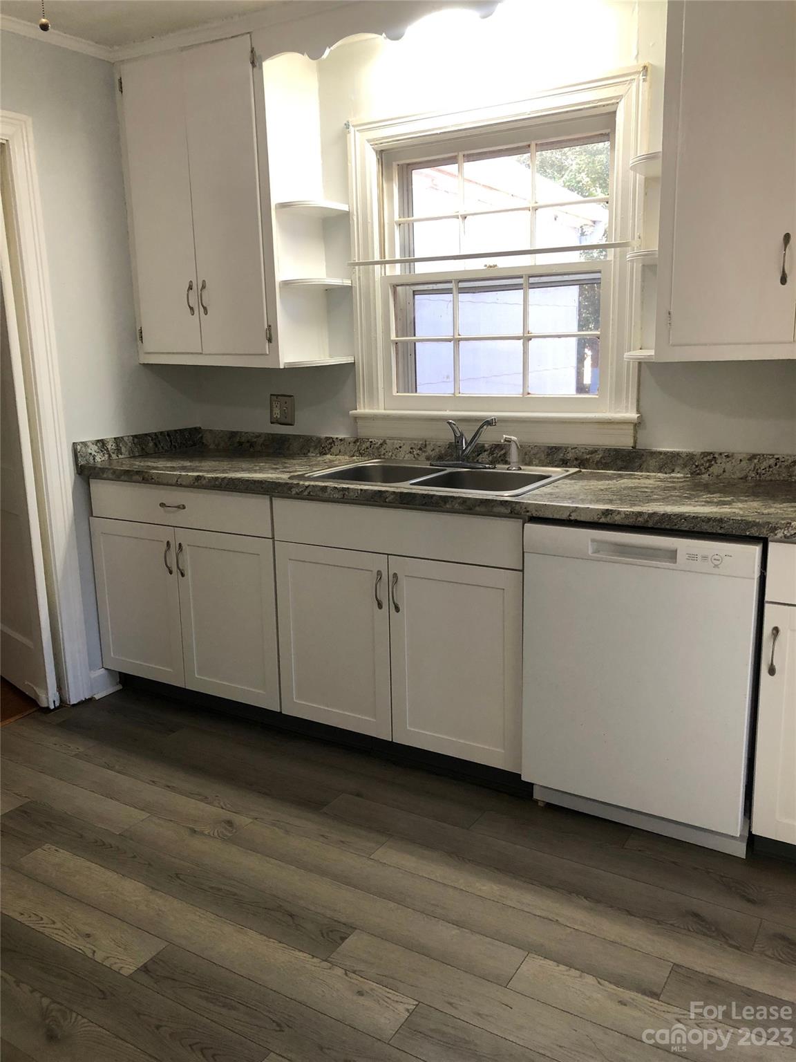 3200 Sam Wilson Road Charlotte, NC 28214 - Photo 6 of 13 a kitchen with granite countertop white cabinets sink and window