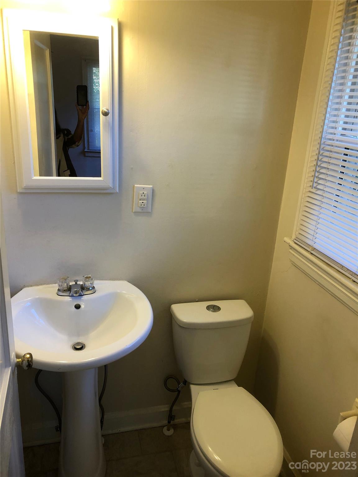 3200 Sam Wilson Road Charlotte, NC 28214 - Photo 8 of 13 a bathroom with a toilet sink and mirror
