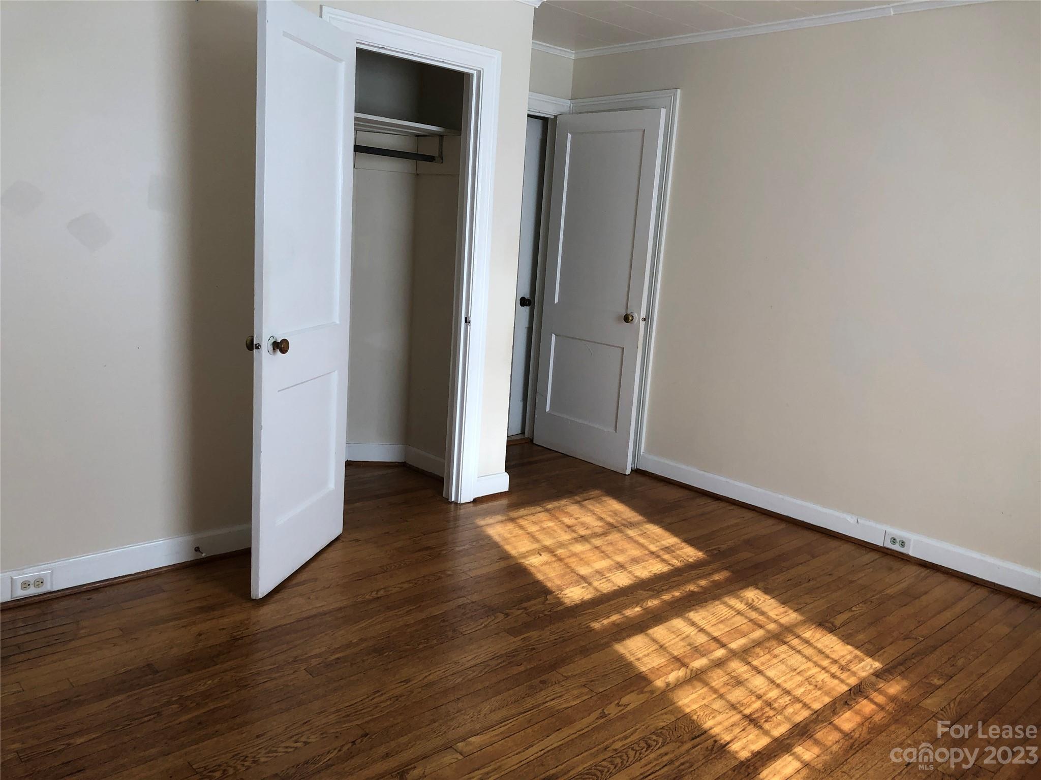 3200 Sam Wilson Road Charlotte, NC 28214 - Photo 9 of 13 an empty room with wooden floor and closet