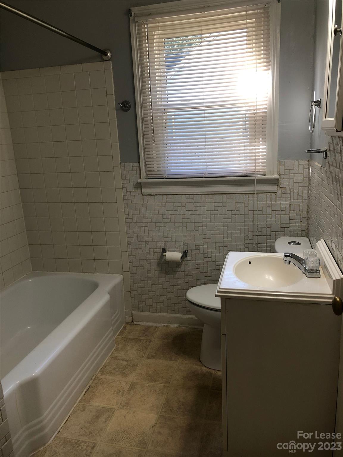 3200 Sam Wilson Road Charlotte, NC 28214 - Photo 10 of 13 a bathroom with a sink a toilet and a bathtub