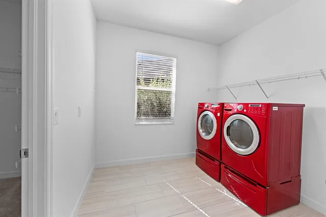 an aerial view of a residential houses with outdoor space and street view