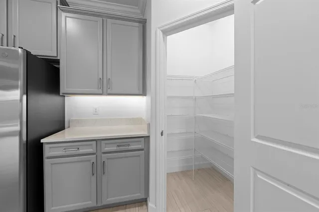 an empty room with windows and chandelier