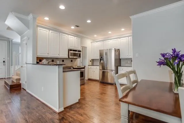 a living room with furniture and kitchen view
