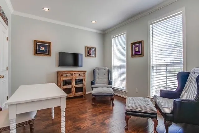 a living room with furniture a flat screen tv and a window