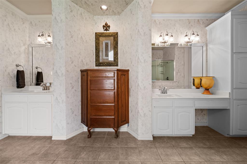 3904 Edna Valley Court Flower Mound, TX 75022 - Photo 21 of 36 a bathroom with a sink a mirror and shower