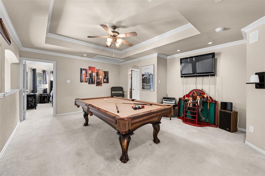 3904 Edna Valley Court Flower Mound, TX 75022 - Photo 23 of 36 a living room with furniture a flat screen tv and kitchen view