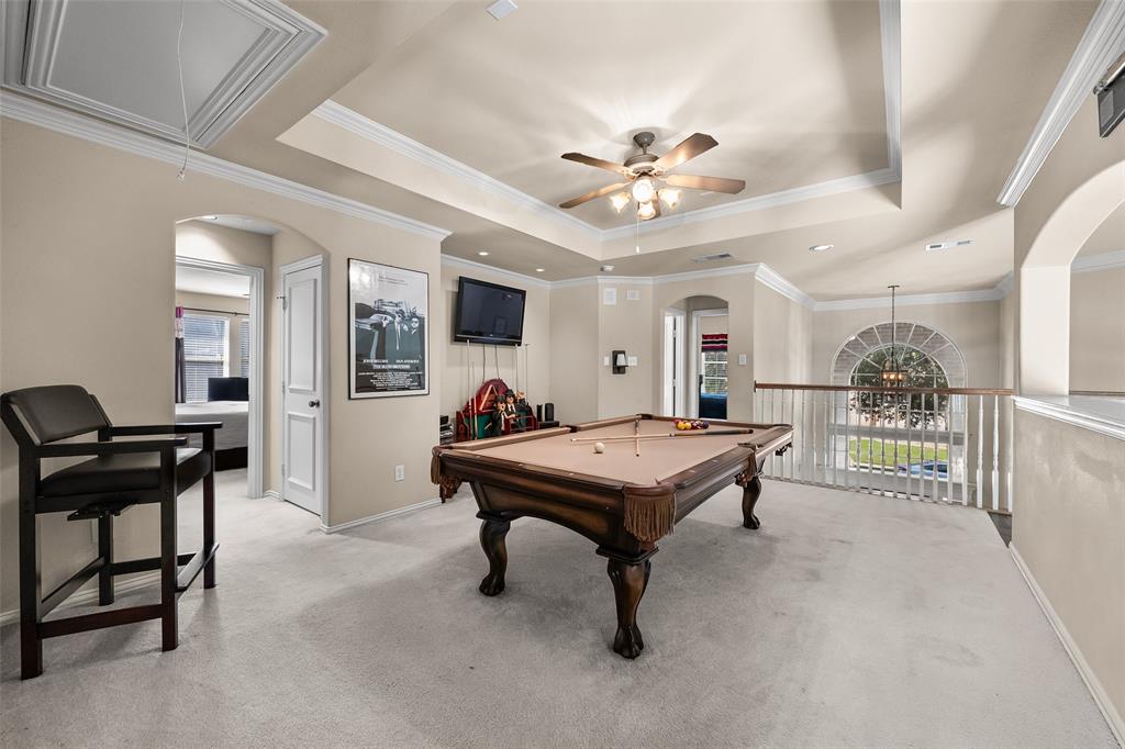 3904 Edna Valley Court Flower Mound, TX 75022 - Photo 24 of 36 a living room with furniture a chandelier a fireplace and a flat screen tv