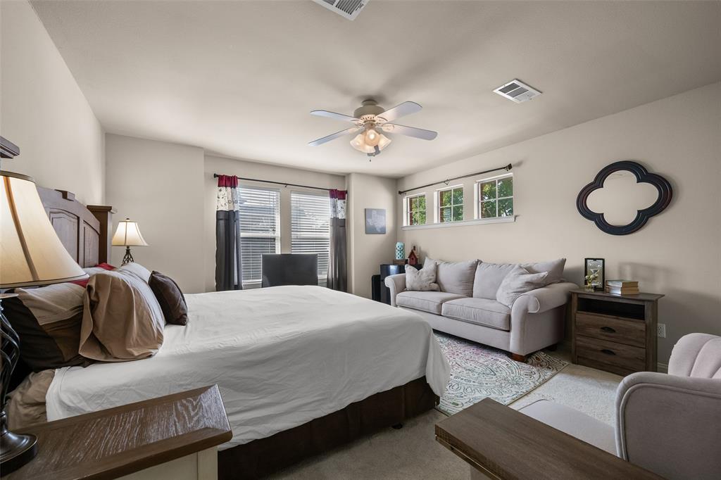 3904 Edna Valley Court Flower Mound, TX 75022 - Photo 26 of 36 a bedroom with a bed couches and wooden floor