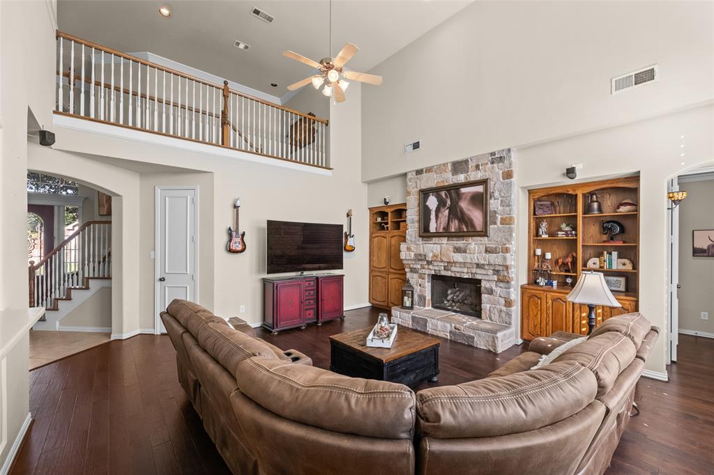 3904 Edna Valley Court Flower Mound, TX 75022 - Photo 8 of 36 a living room with fireplace furniture and a flat screen tv