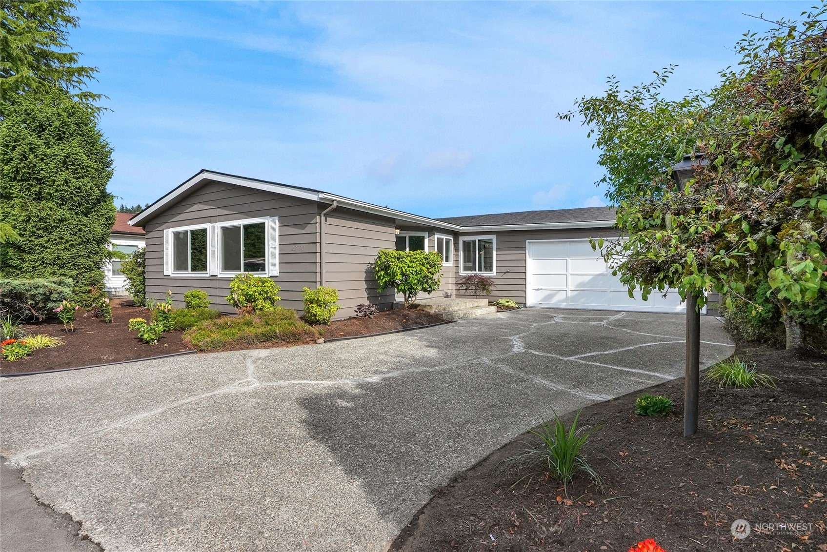 23730 Vista View Avenue Bothell, WA 98021 - Photo 1 of 3 a front view of a house with a yard and garage