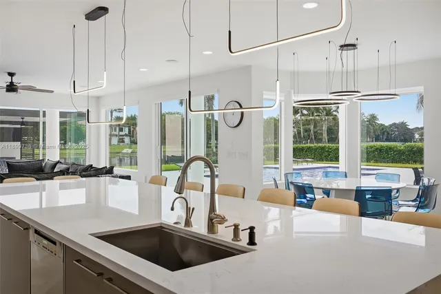a living room with furniture and kitchen view