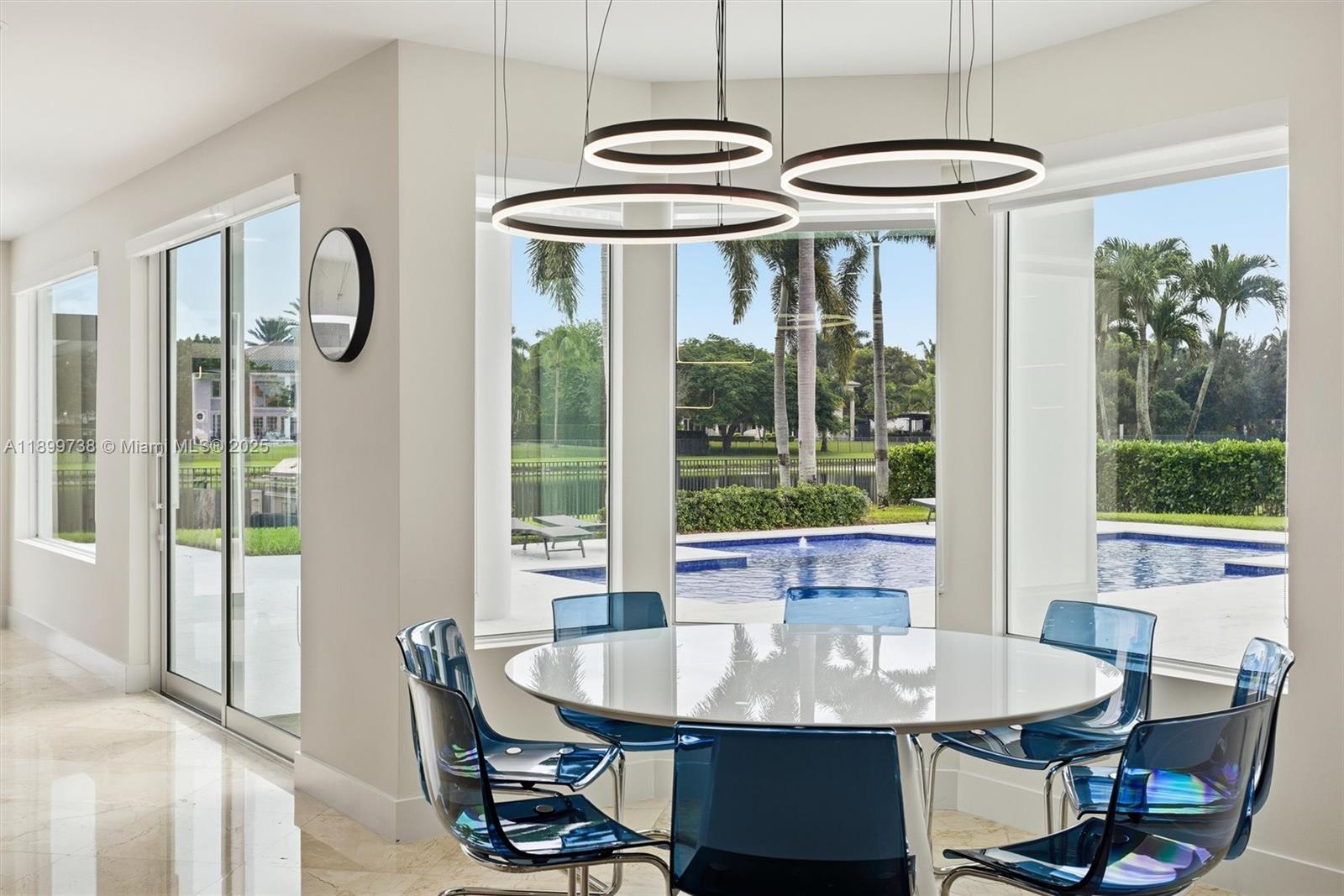 3526 Juniper Lane Davie, FL 33330 - Photo 22 of 79 a dining room with furniture a chandelier and wooden floor