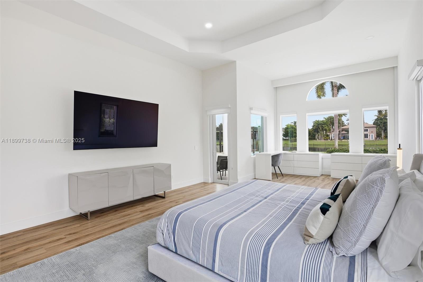 3526 Juniper Lane Davie, FL 33330 - Photo 29 of 79 a bedroom with a bed and a flat screen tv