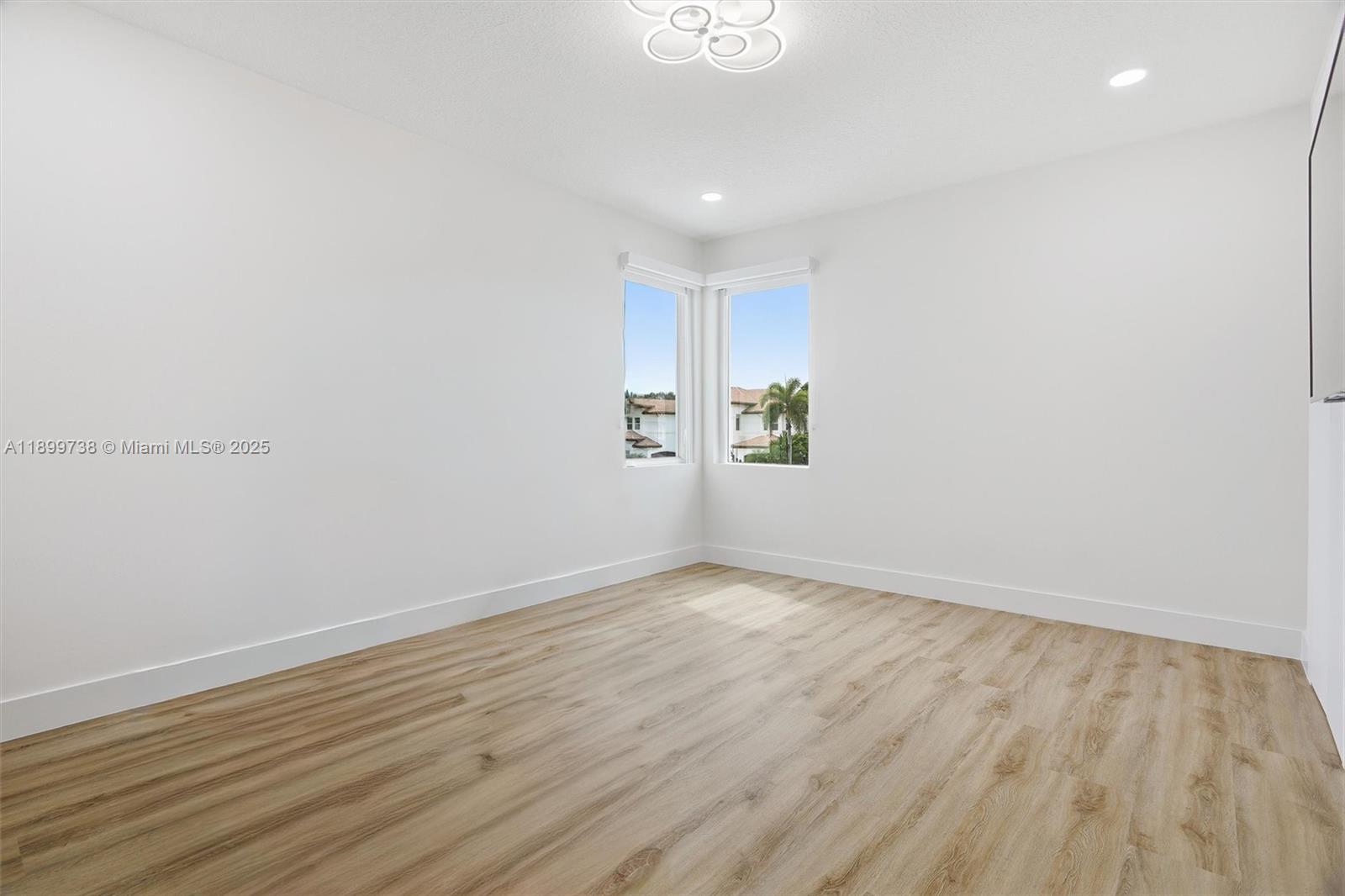 3526 Juniper Lane Davie, FL 33330 - Photo 49 of 79 a view of an empty room with wooden floor and a window