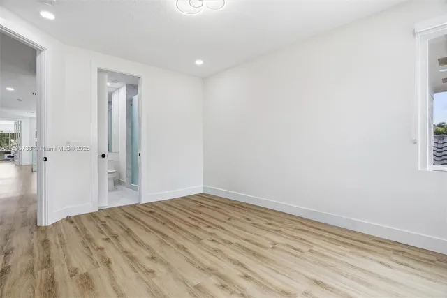 an aerial view of residential houses with outdoor space and lake view