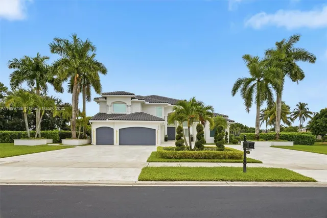a white house with palm tree in front of it