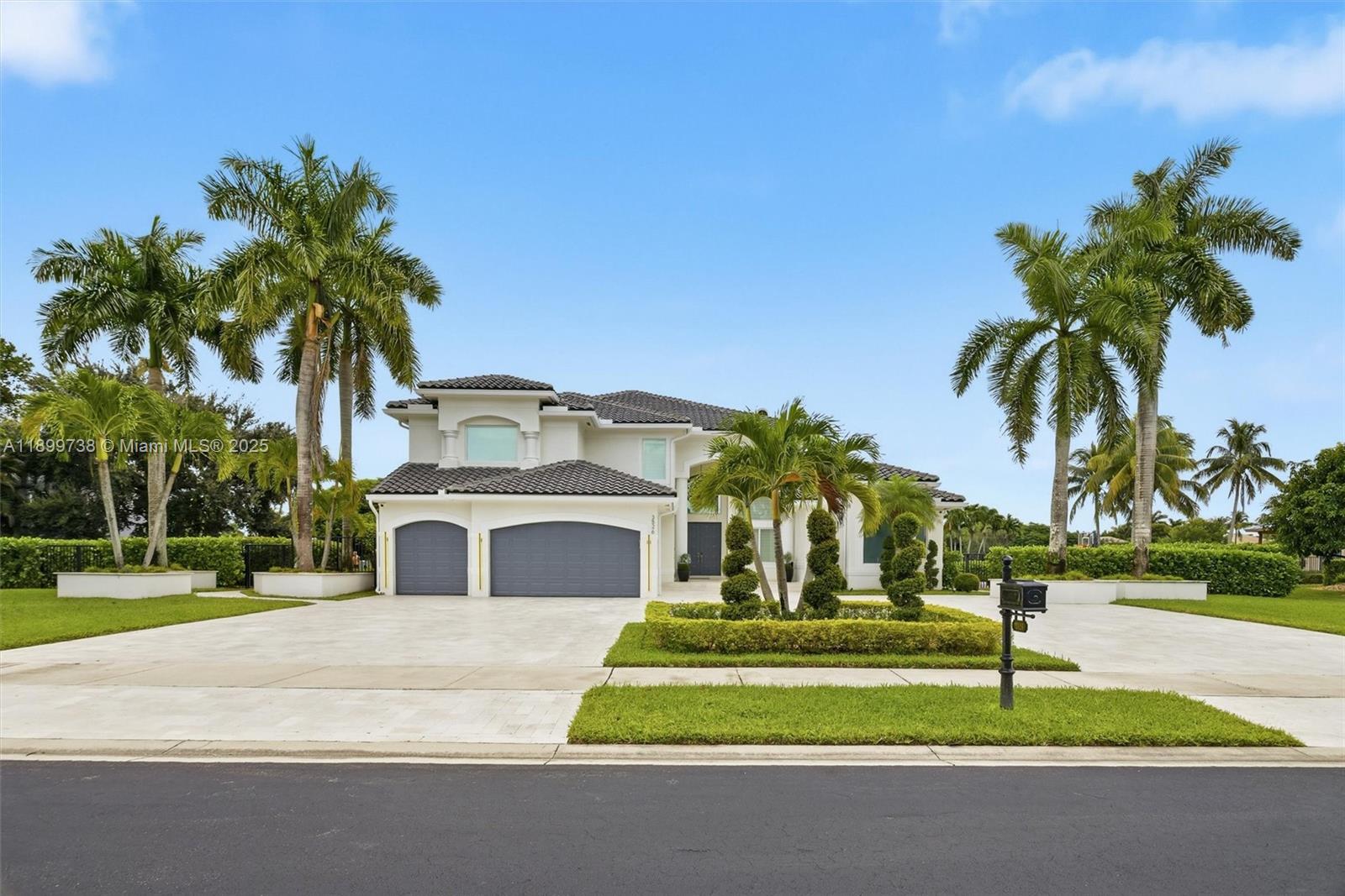 3526 Juniper Lane Davie, FL 33330 - Photo 5 of 79 a white house with palm tree in front of it
