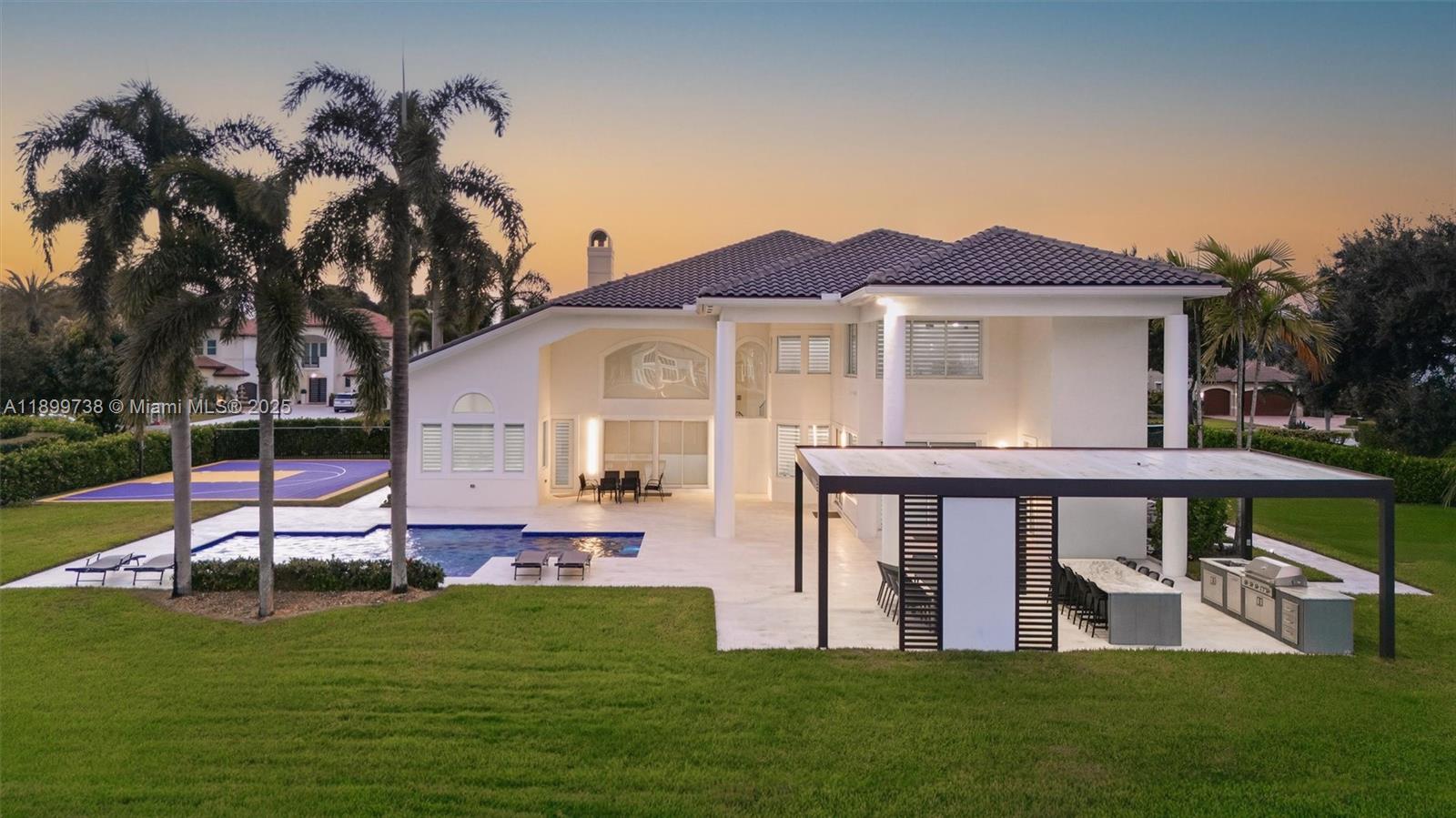 3526 Juniper Lane Davie, FL 33330 - Photo 56 of 79 a front view of a house with a yard table and chairs