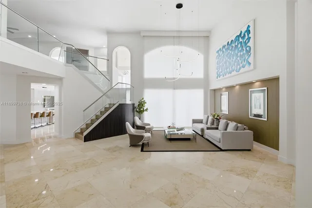 a view of a dining room with furniture and chandelier