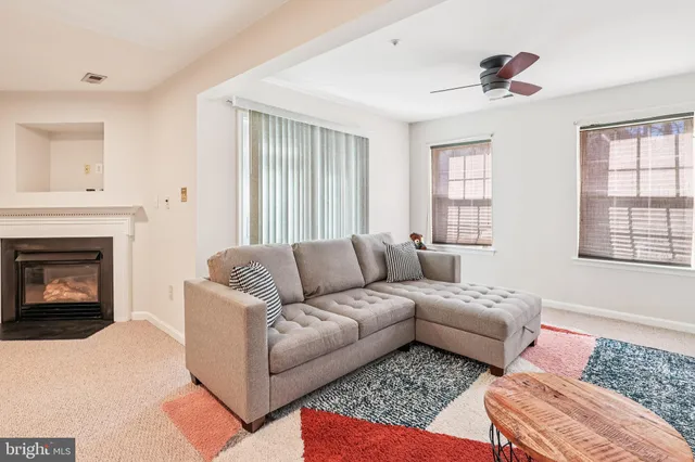 a living room with furniture fireplace and window