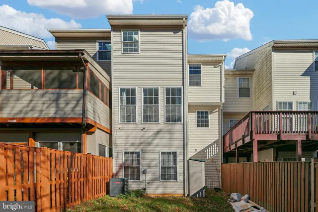 a view of a big house with a big yard and large trees