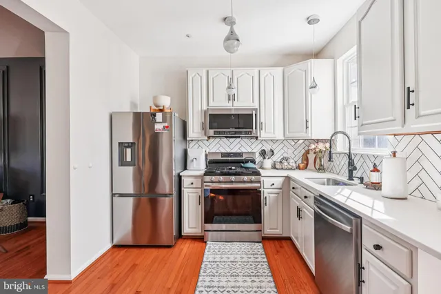 a kitchen with a sink stove and refrigerator