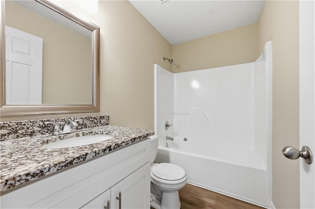 1730 Alcovy River Drive Dacula, GA 30019 - Photo 15 of 30 a bathroom with a sink toilet vanity and shower