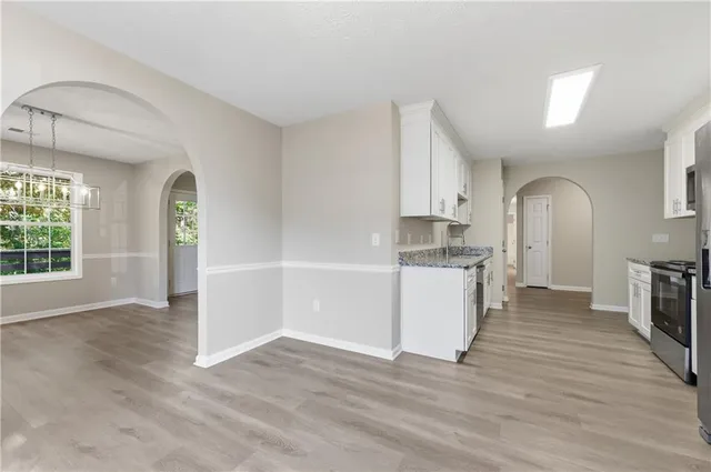 an empty room with wooden floor and a window