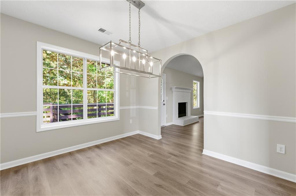 1730 Alcovy River Drive Dacula, GA 30019 - Photo 9 of 30 a view of a room with wooden flooring and chandelier