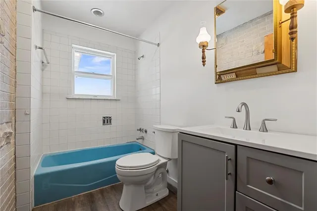 a bathroom with a sink a toilet and mirror