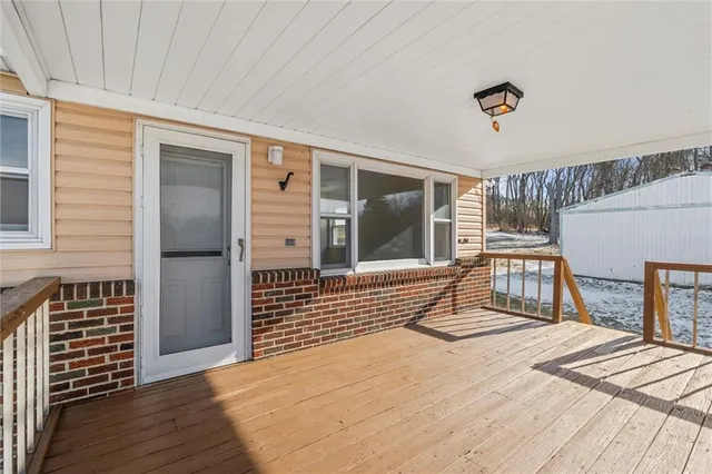 a view of a balcony with wooden floor