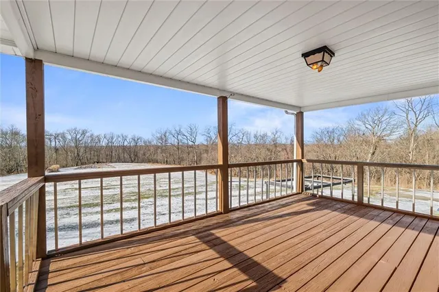 a view of a balcony with furniture and wooden floor