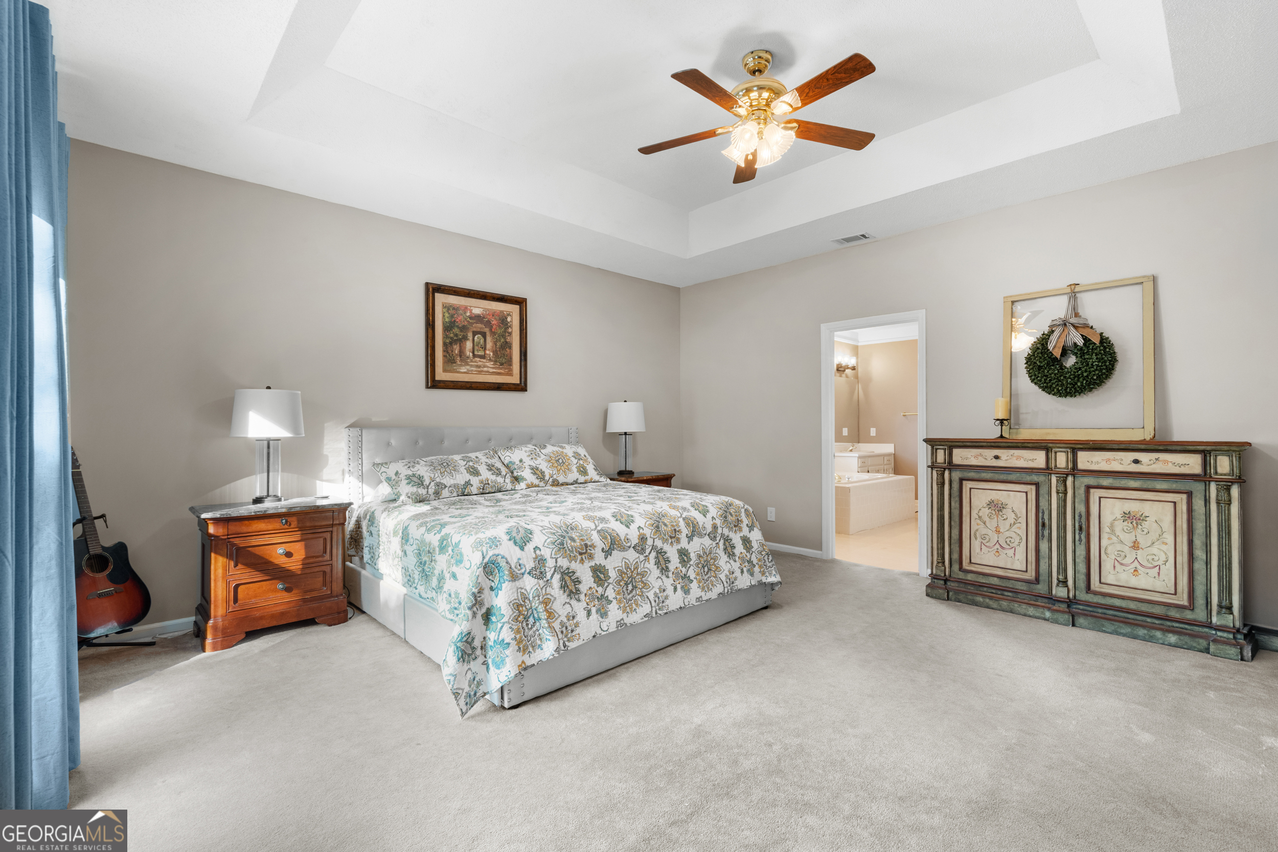 1018 Hunters Pointe Drive Statesboro, GA 30461 - Photo 12 of 21 a spacious bedroom with a bed and a chandelier