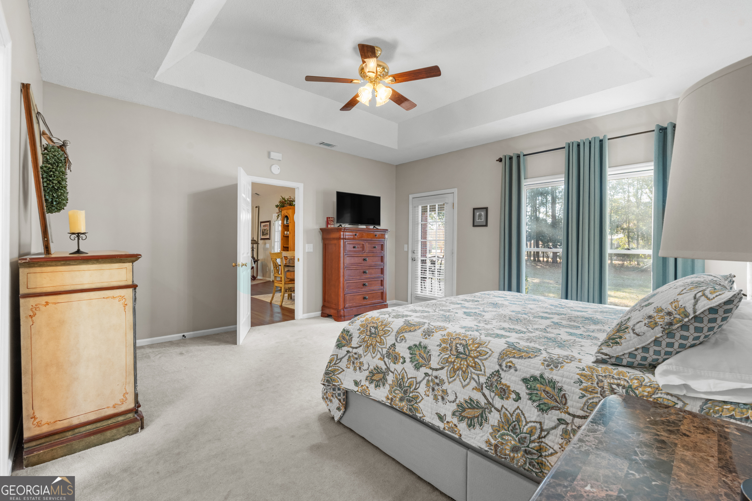 1018 Hunters Pointe Drive Statesboro, GA 30461 - Photo 13 of 21 a bedroom with a large bed and a chandelier