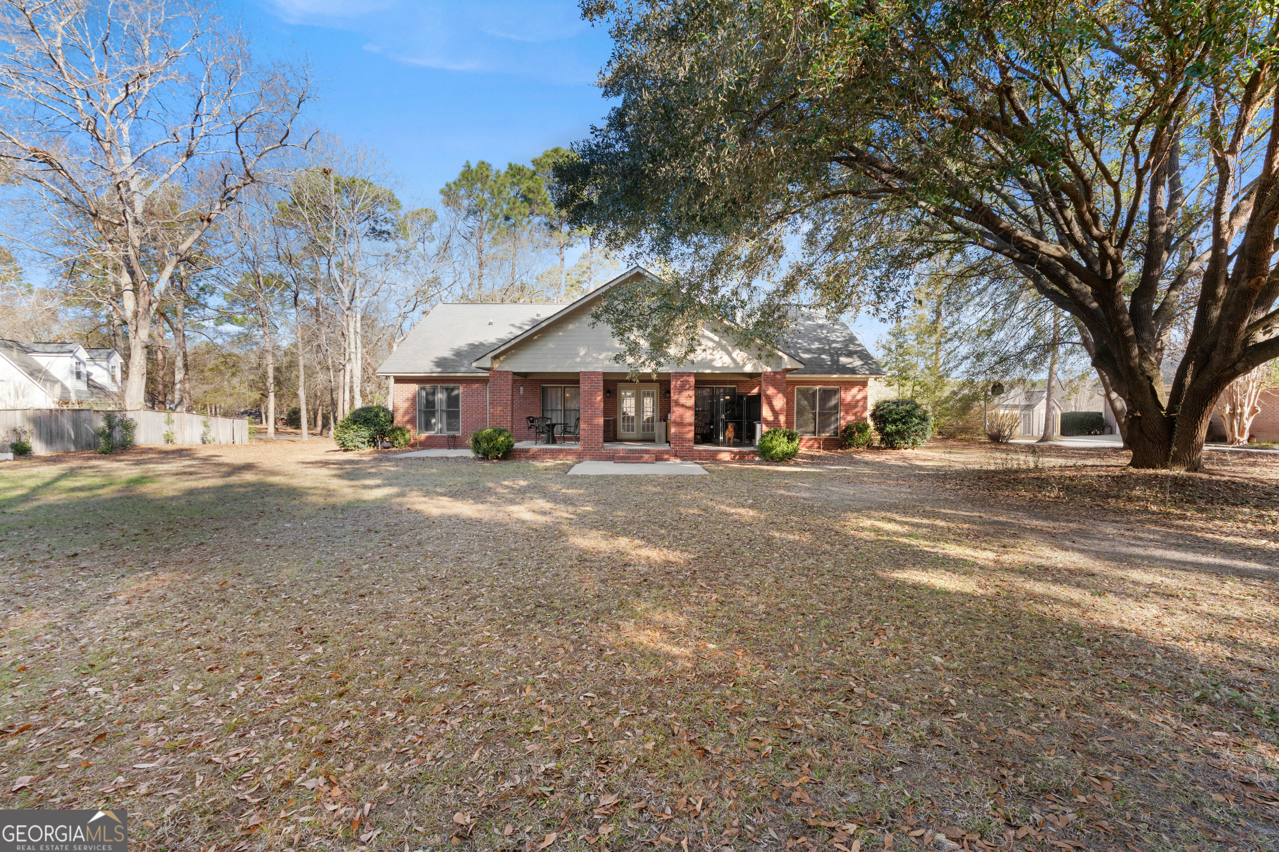 1018 Hunters Pointe Drive Statesboro, GA 30461 - Photo 20 of 21 a front view of a house with a yard and trees