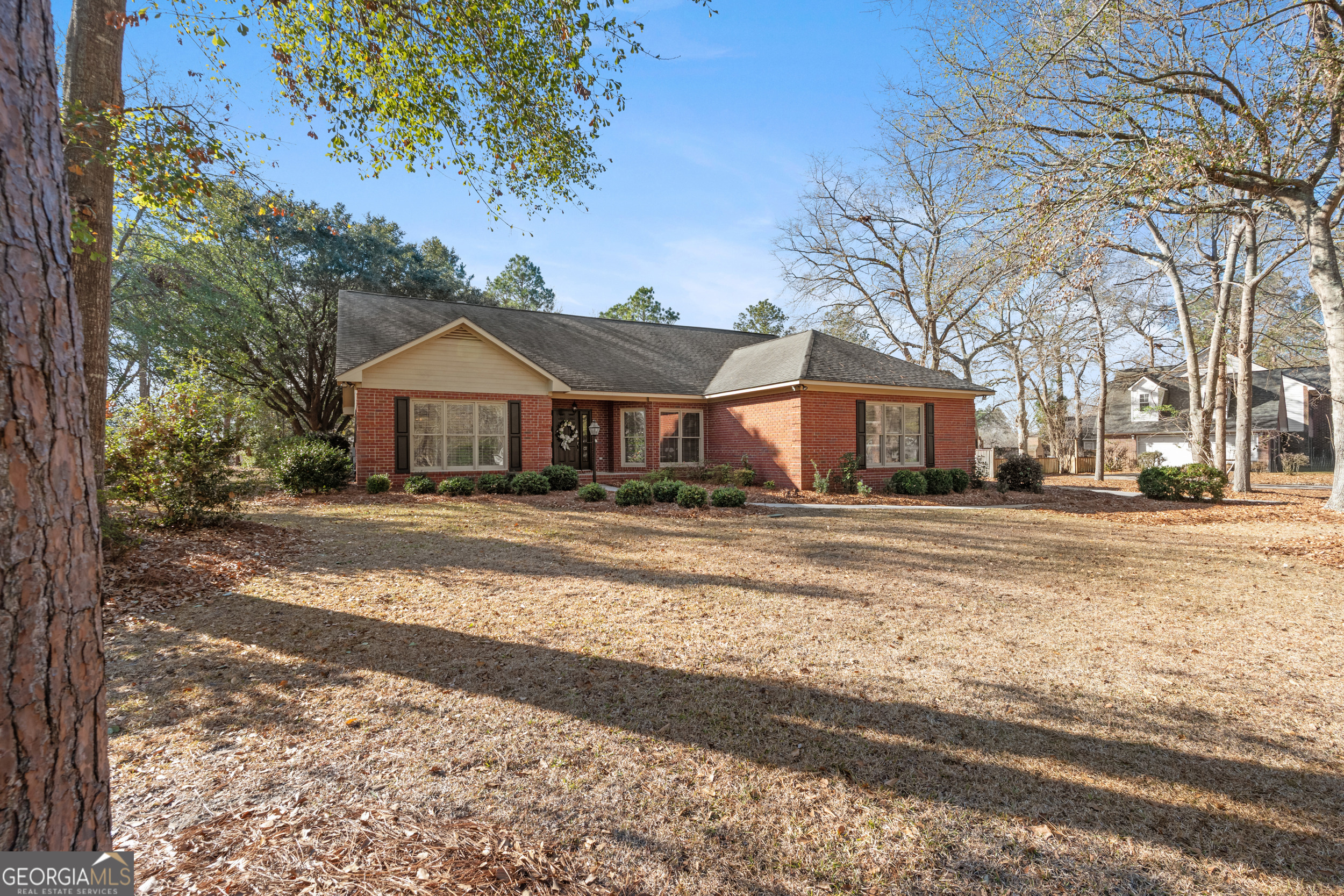 1018 Hunters Pointe Drive Statesboro, GA 30461 - Photo 2 of 21 a front view of a house with a yard covered with snow and trees
