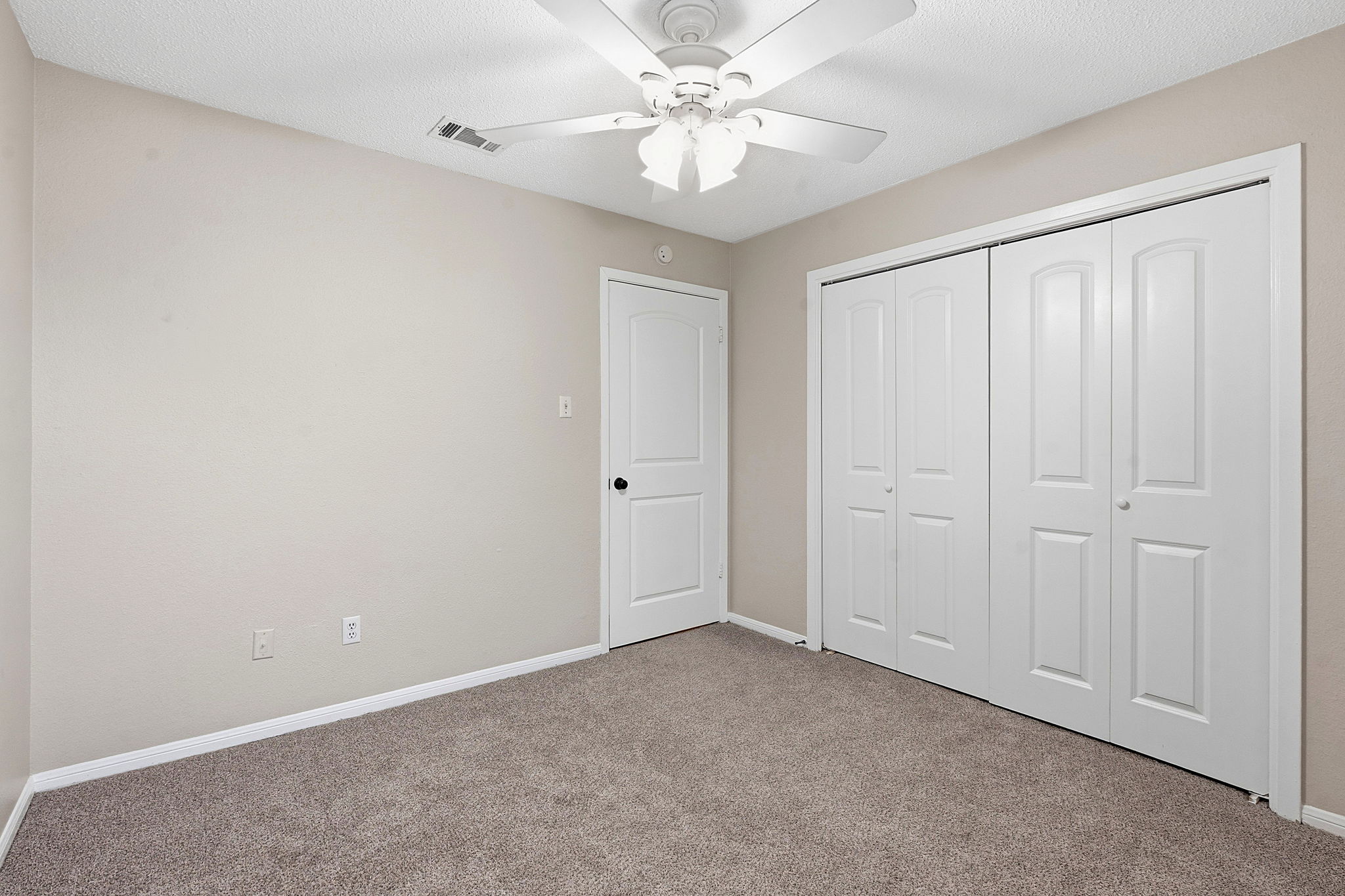 8811 Schick Road Austin, TX 78729 - Photo 18 of 27 A well-proportioned bedroom offers comfort with plush carpeting and convenient closet space.