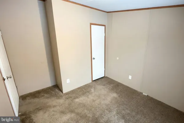 an empty room with closet area