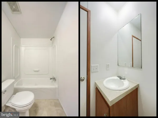 a bathroom with a sink a tub and a mirror
