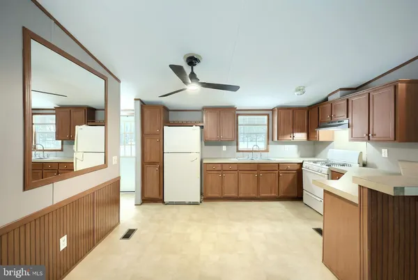 a kitchen with granite countertop a sink and cabinets