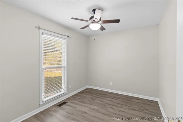 a view of a room with wooden floor