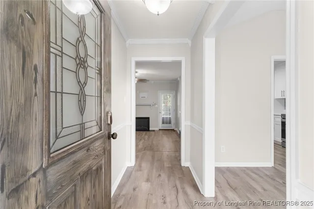 a view of a hallway with wooden floor and staircase