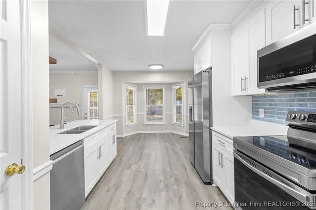 a kitchen with a sink stove and refrigerator