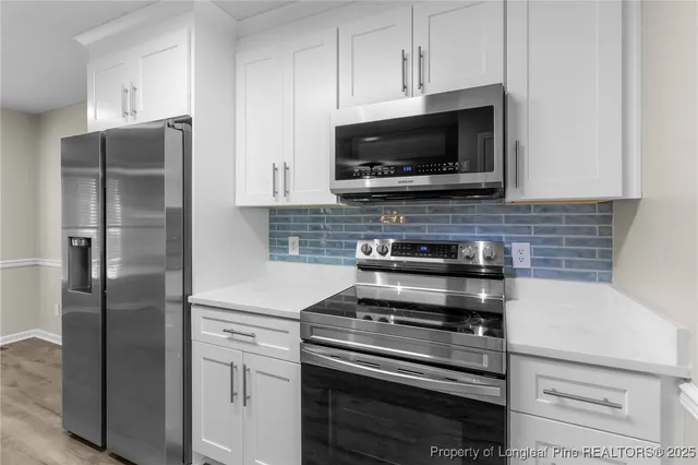 a kitchen with stainless steel appliances a refrigerator stove and microwave