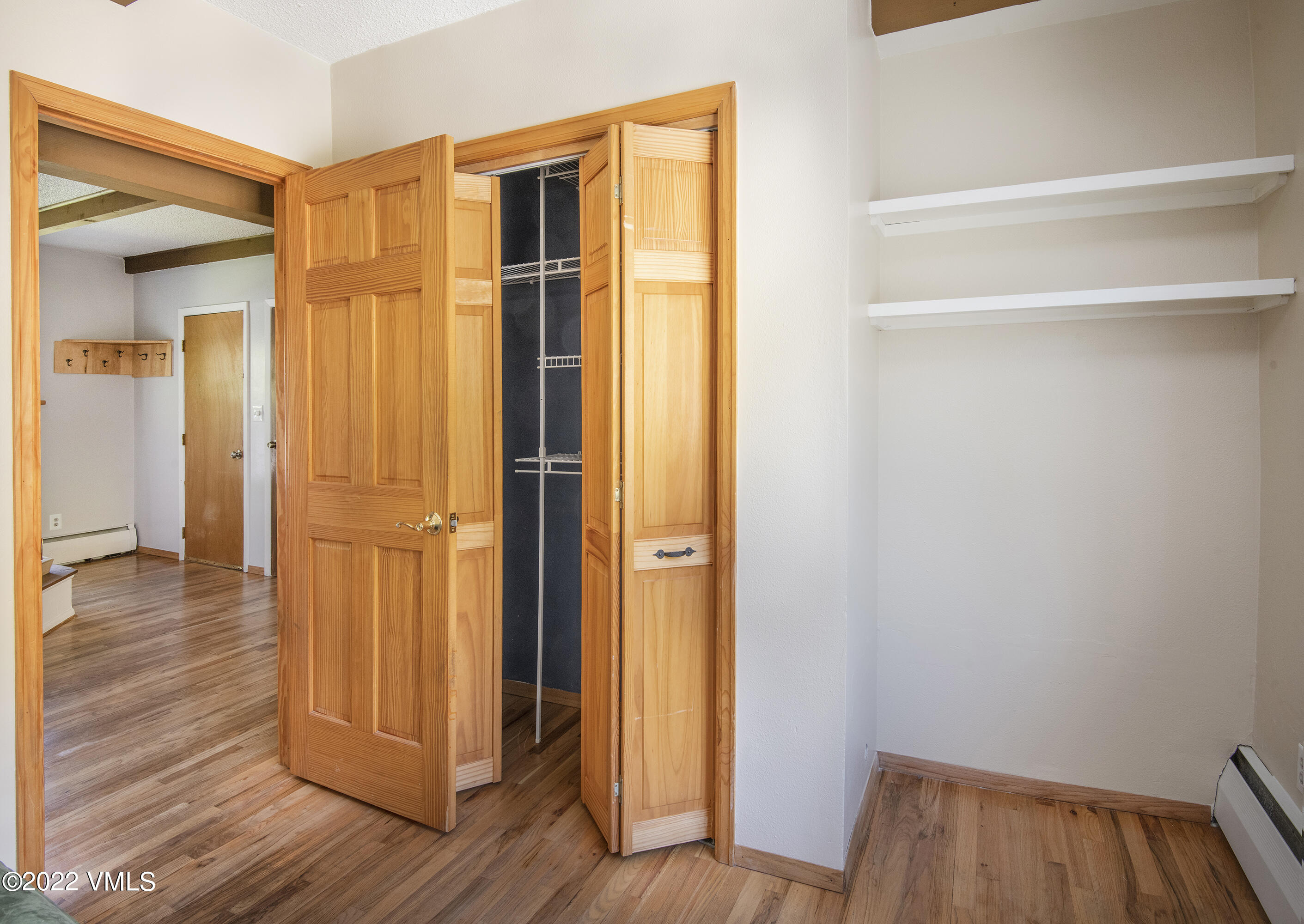 4073 Spruce Way, Unit 22 Vail, CO 81657 - Photo 15 of 25 a view of a hallway with wooden floor and closet