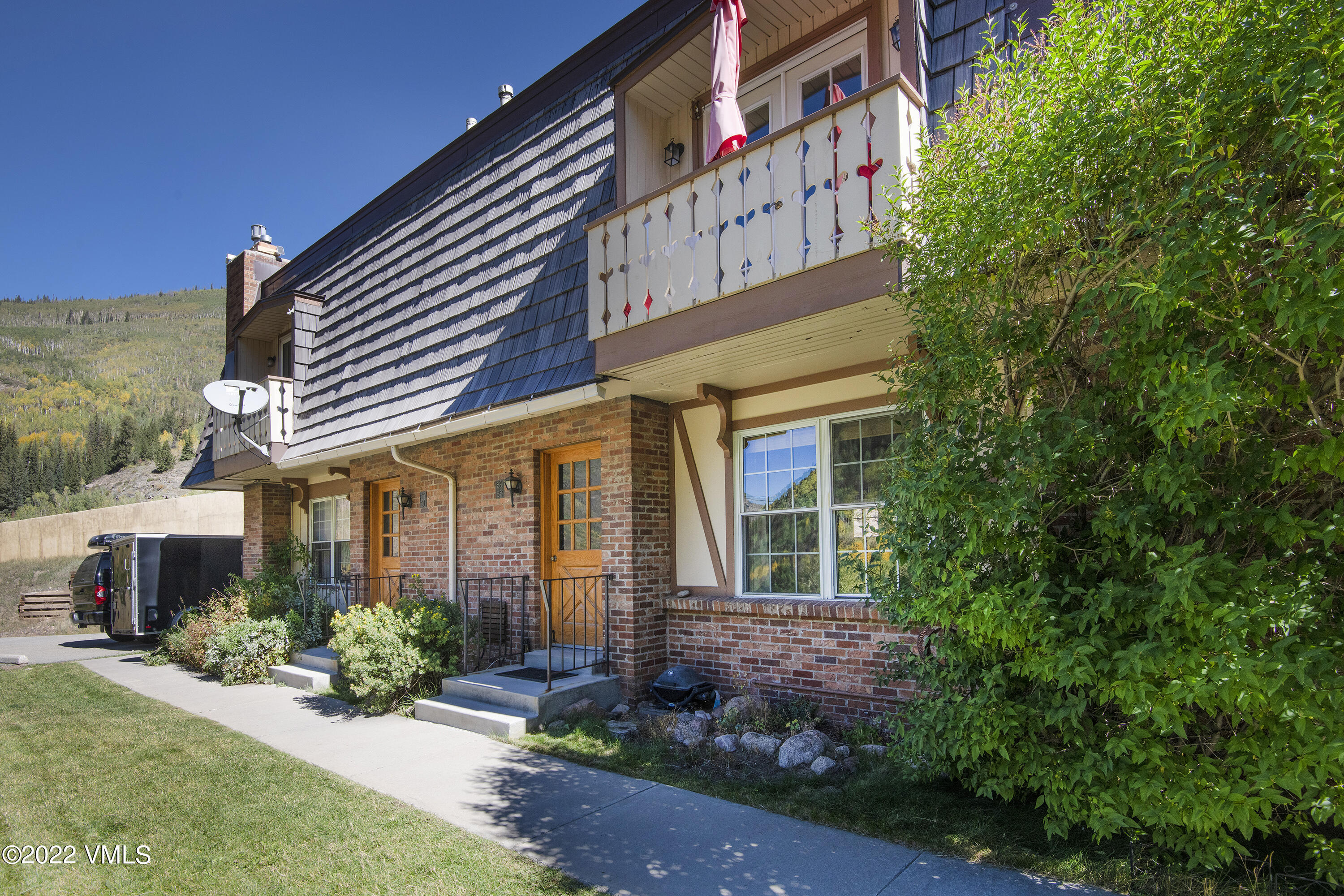 4073 Spruce Way, Unit 22 Vail, CO 81657 - Photo 17 of 25 a front view of a house with a yard