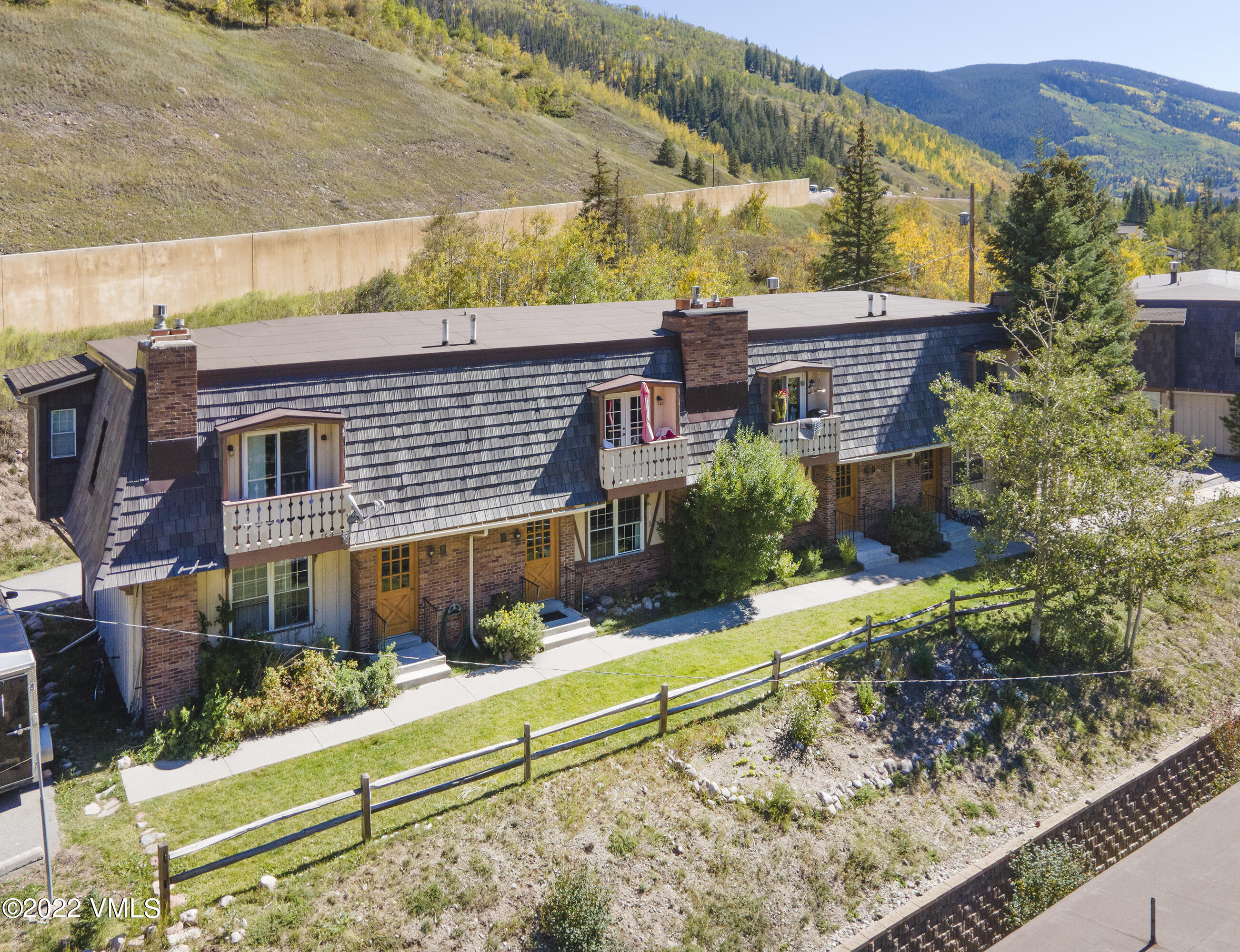 4073 Spruce Way, Unit 22 Vail, CO 81657 - Photo 18 of 25 a view of a house with a yard and sitting area
