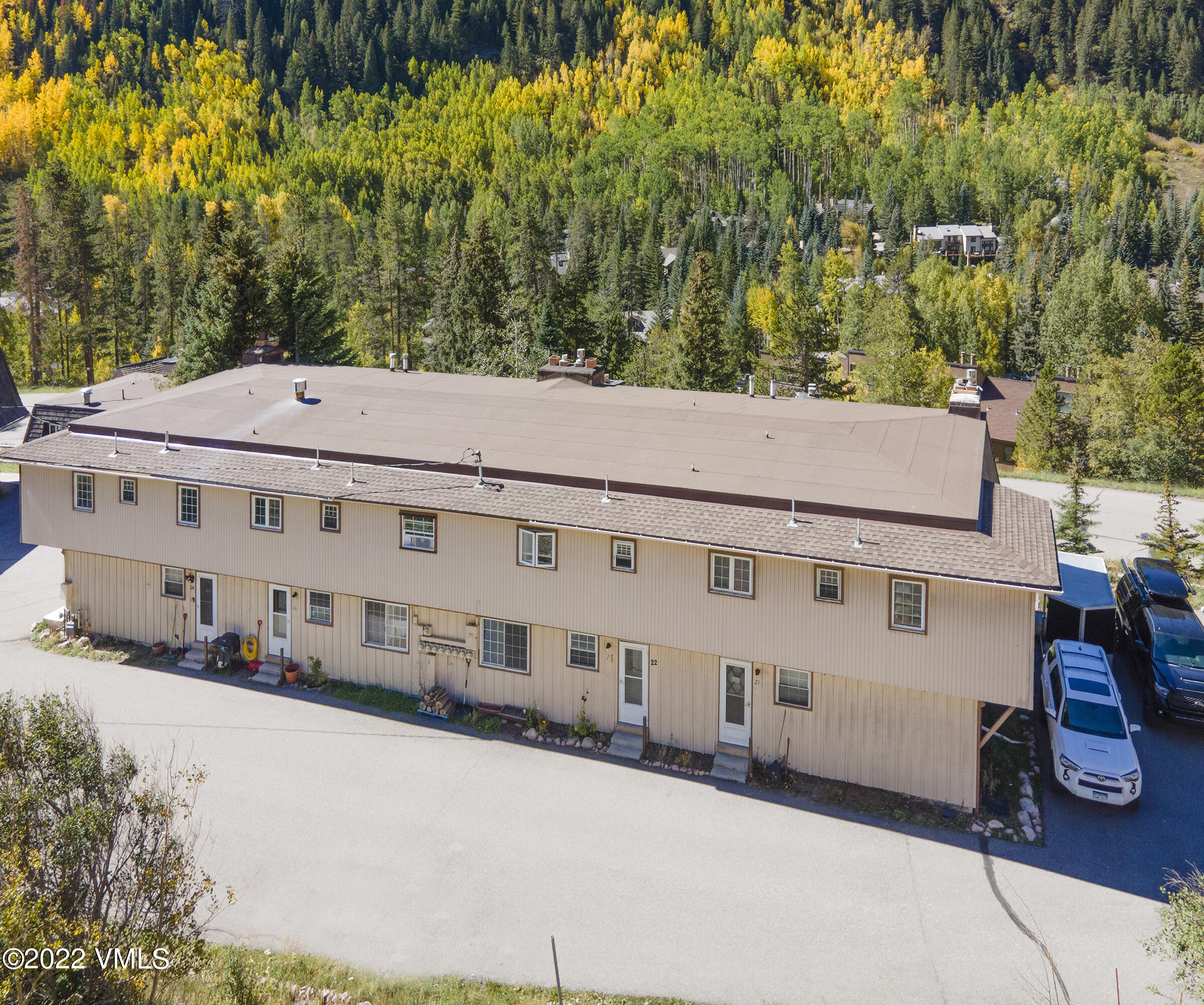 4073 Spruce Way, Unit 22 Vail, CO 81657 - Photo 20 of 25 a large building with a large tree in front of it