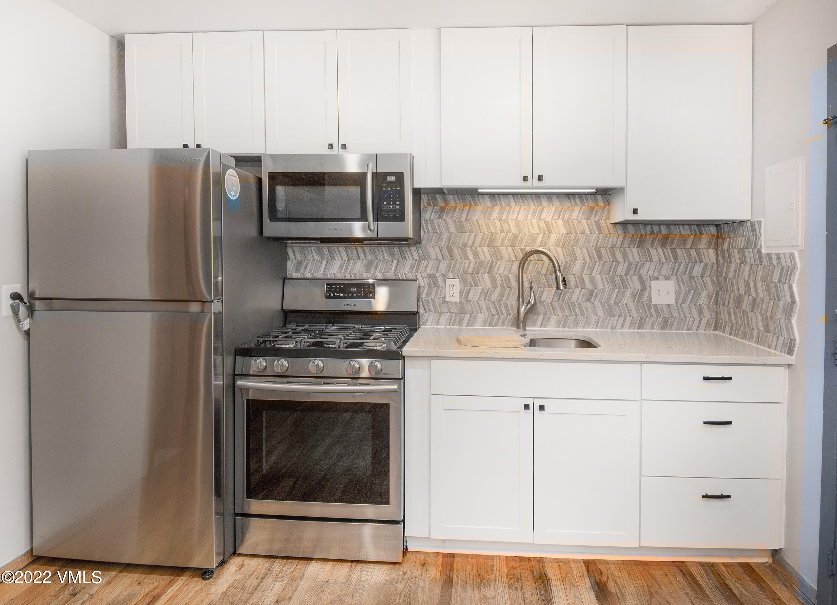 4073 Spruce Way, Unit 22 Vail, CO 81657 - Photo 8 of 25 a kitchen with stainless steel appliances granite countertop a sink stove and refrigerator