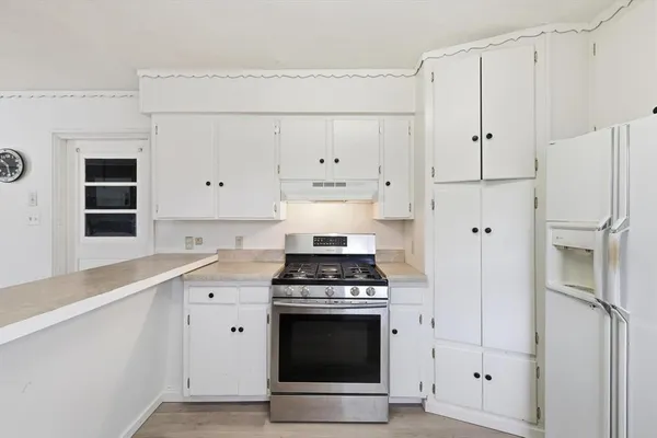a kitchen with cabinets and appliances